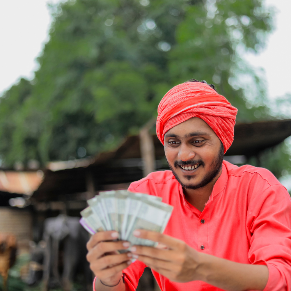 A rural milkman, counting cash received from an individual loan disbursed by an NBFC using Twinline.org's lending software.